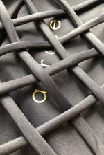 Load image into Gallery viewer, Close-up of black recycled fabric 
