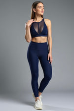 Load image into Gallery viewer, Woman wearing a navy blue athletic outfit on a gray background
